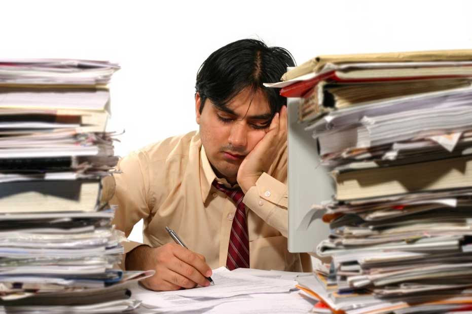 Tired-clerk-with-paper-on-desk