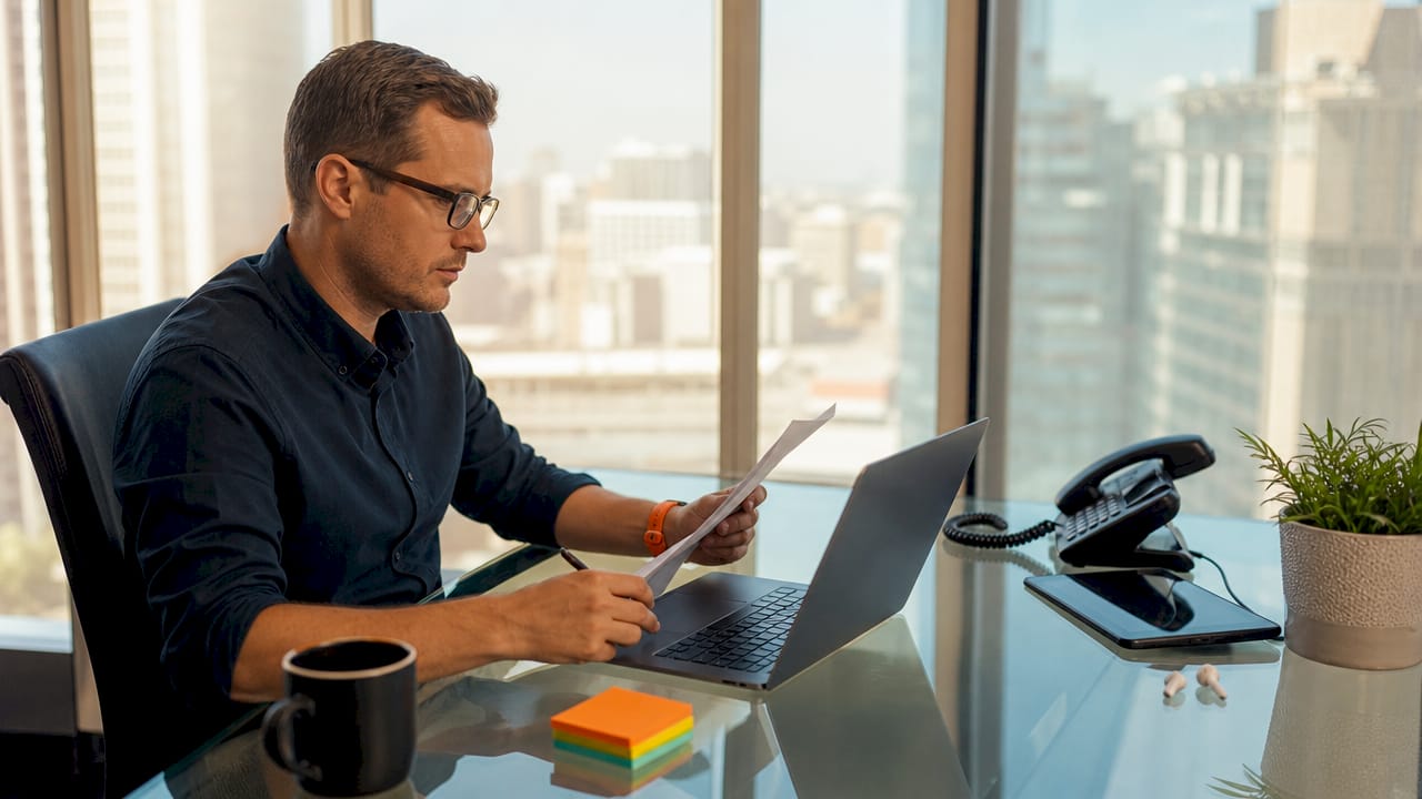 Small business owner reviewing communication costs