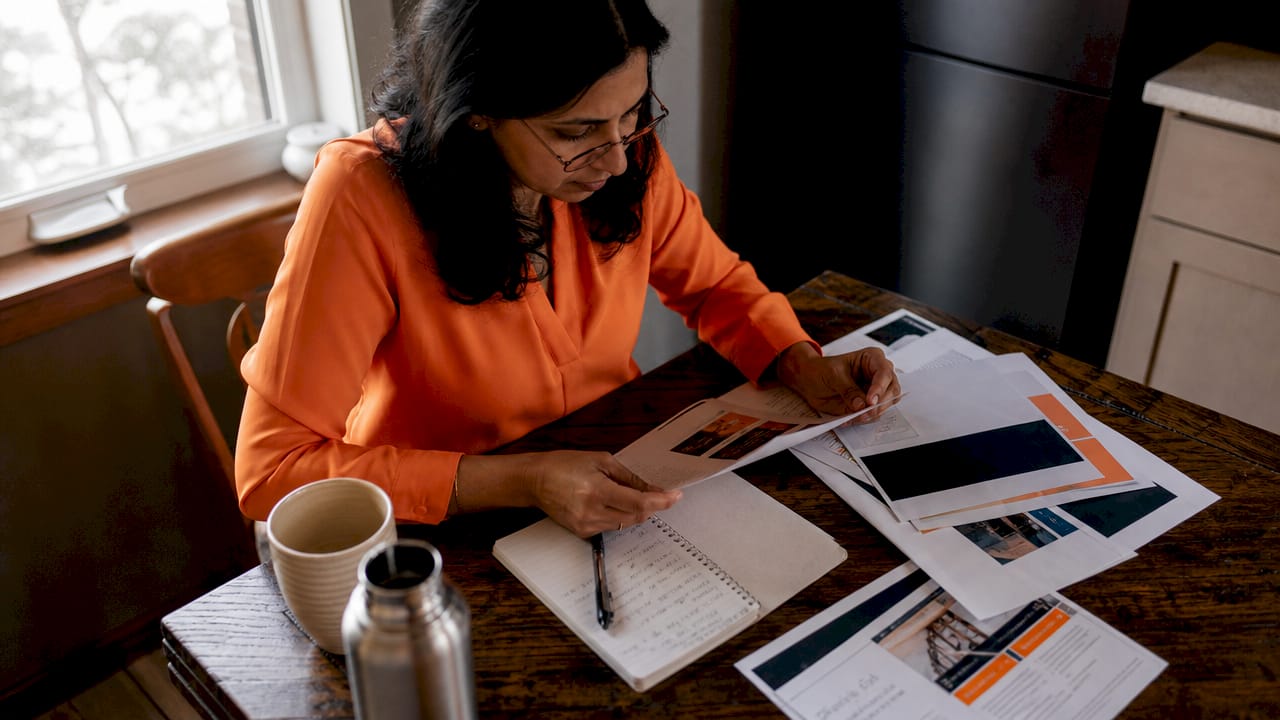 Businesswoman reviewing business phone plan documents