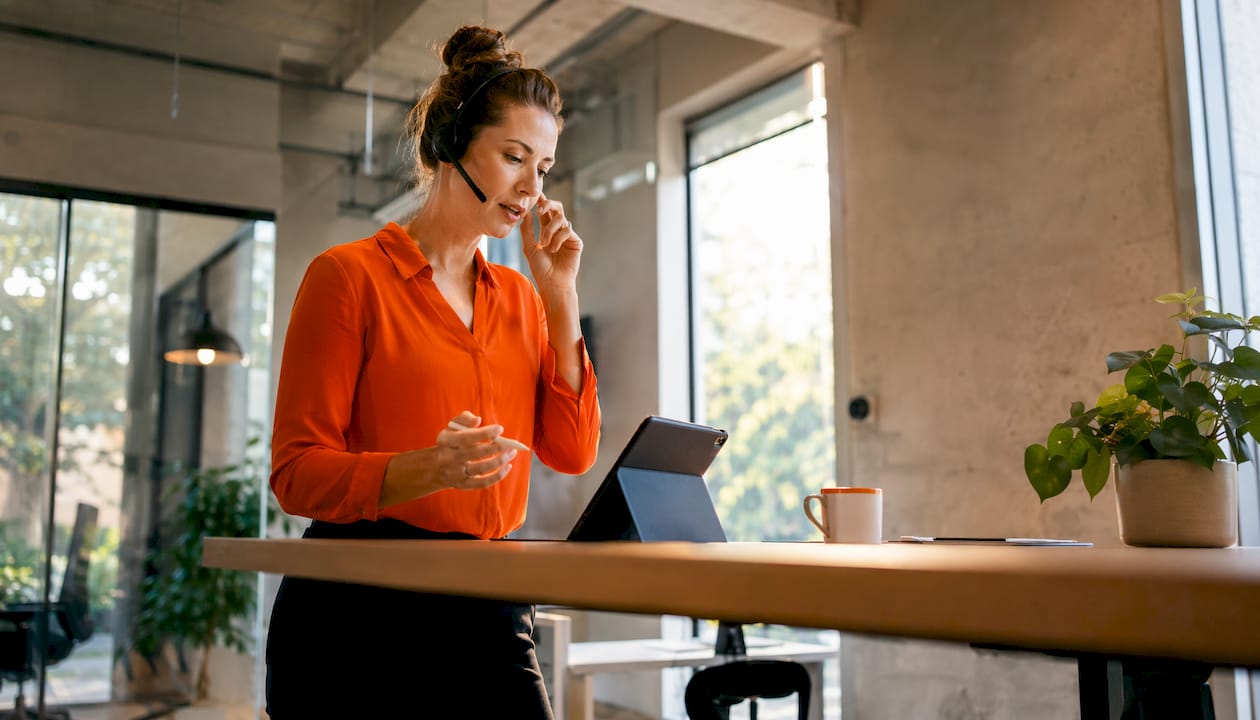 Businesswoman on call using integrated phone system
