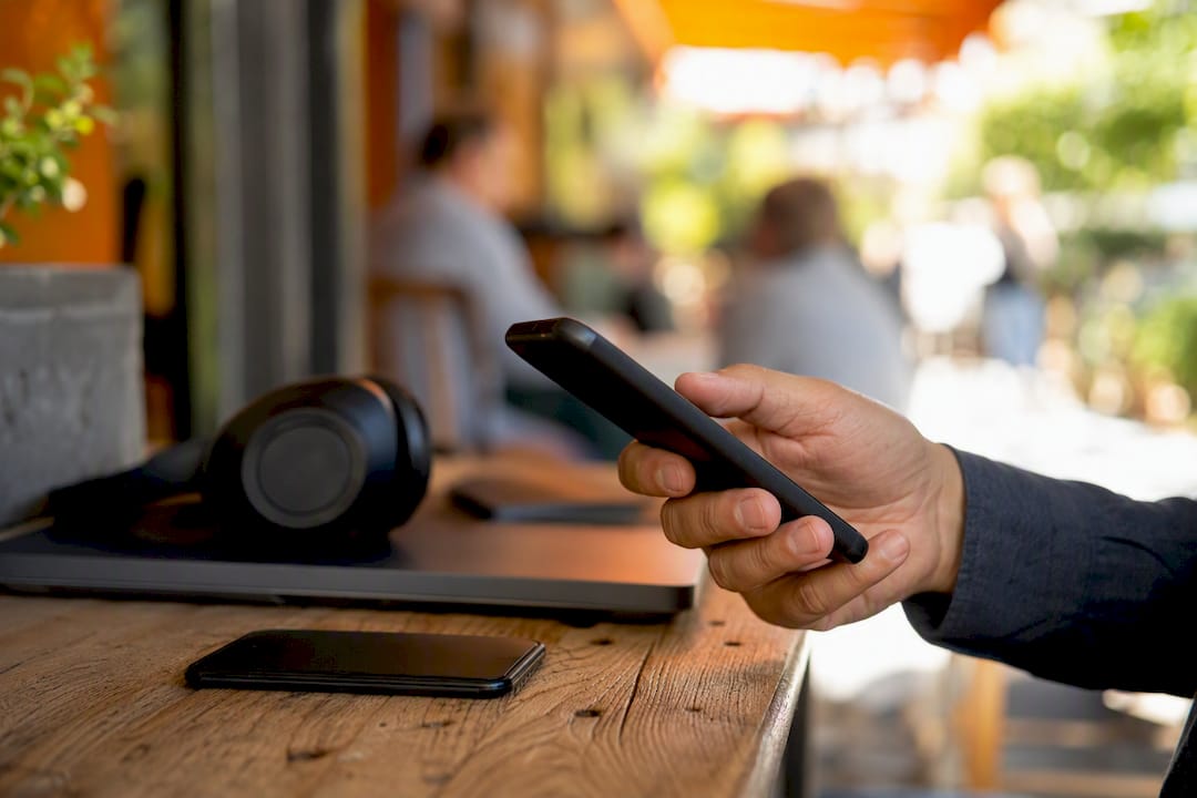 Hand holding mobile phone in business setting
