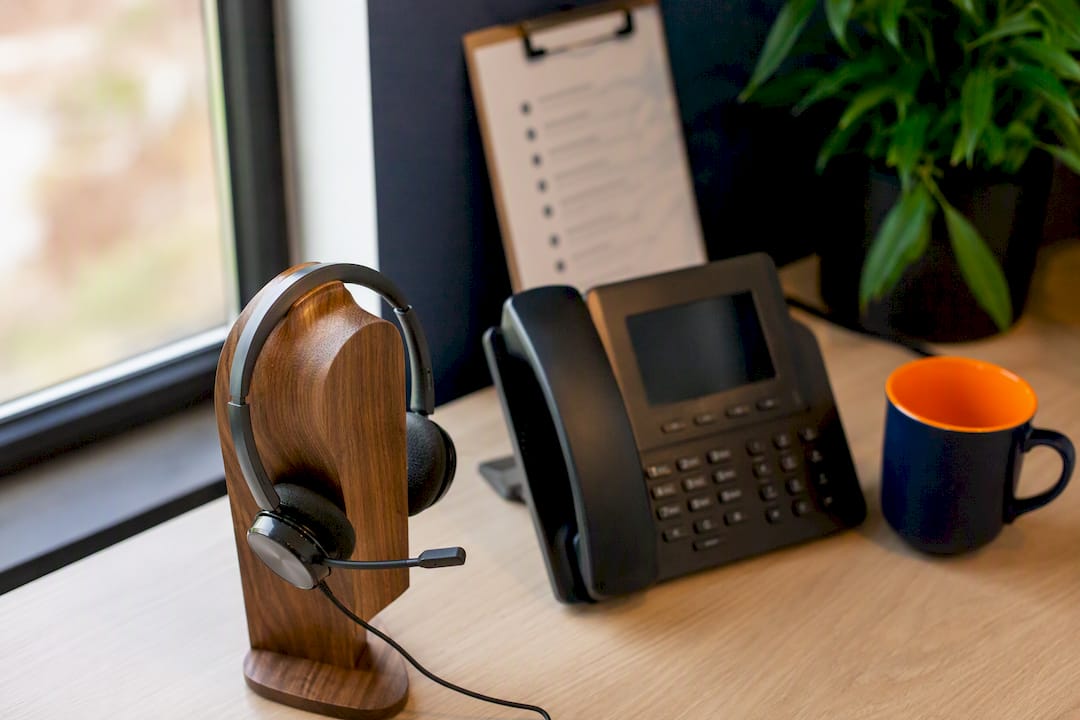 Headset and phone on business desk