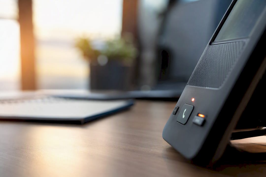 Close-up of business phone with call recording light
