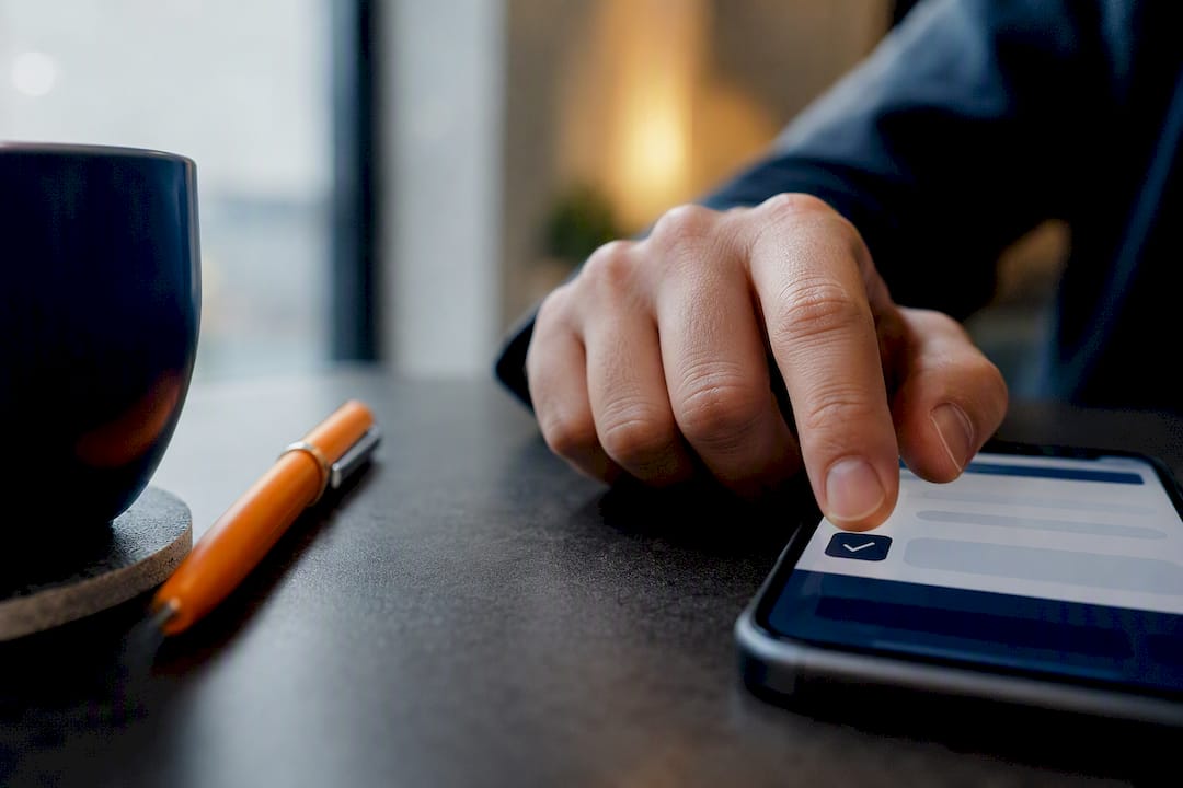Hand reviewing SMS consent opt-in