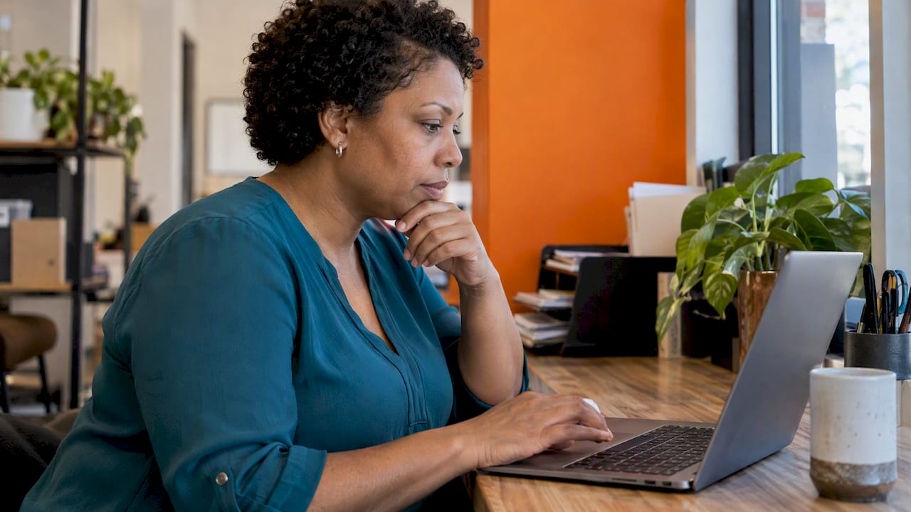 Owner comparing business calling options on a laptop